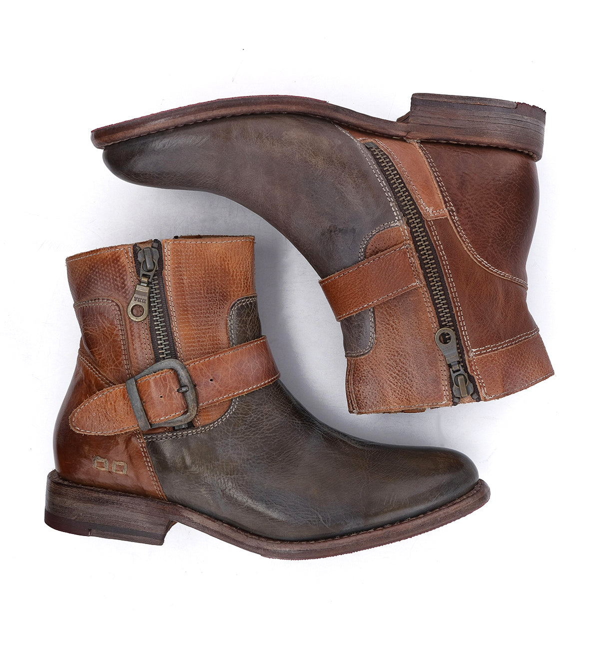 Pair of Becca brown leather ankle boots by Bed|Stü, featuring a sturdy leather shaft, side zippers, and ankle buckles, shown from the side and bottom against a white background.