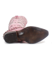 A pink studded cowboy boot from Bed|Stü’s Betting collection is shown from the bottom, revealing a brown sole with the brand name "Bed|Stü" embossed near the heel. This handcrafted leather boot features shimmering studded harness details, adding a bold touch to its signature style.
