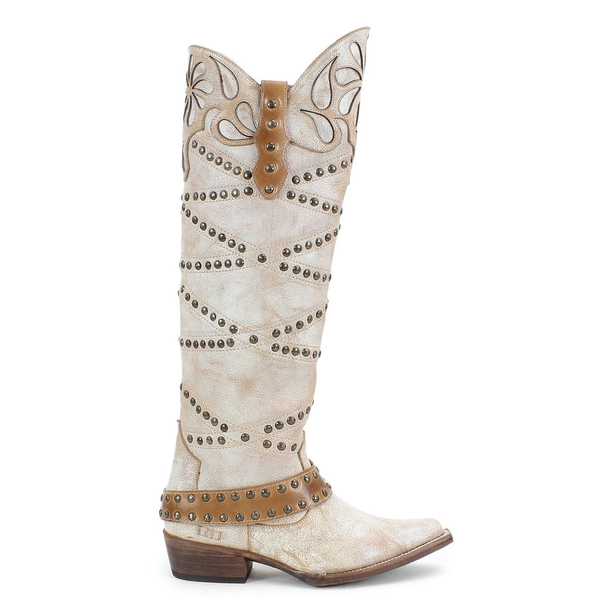 The Bed|Stü Betting boot is a tall, light brown handcrafted leather style featuring decorative stitching, studded harness accents, and a low heel, displayed in profile against a white background.