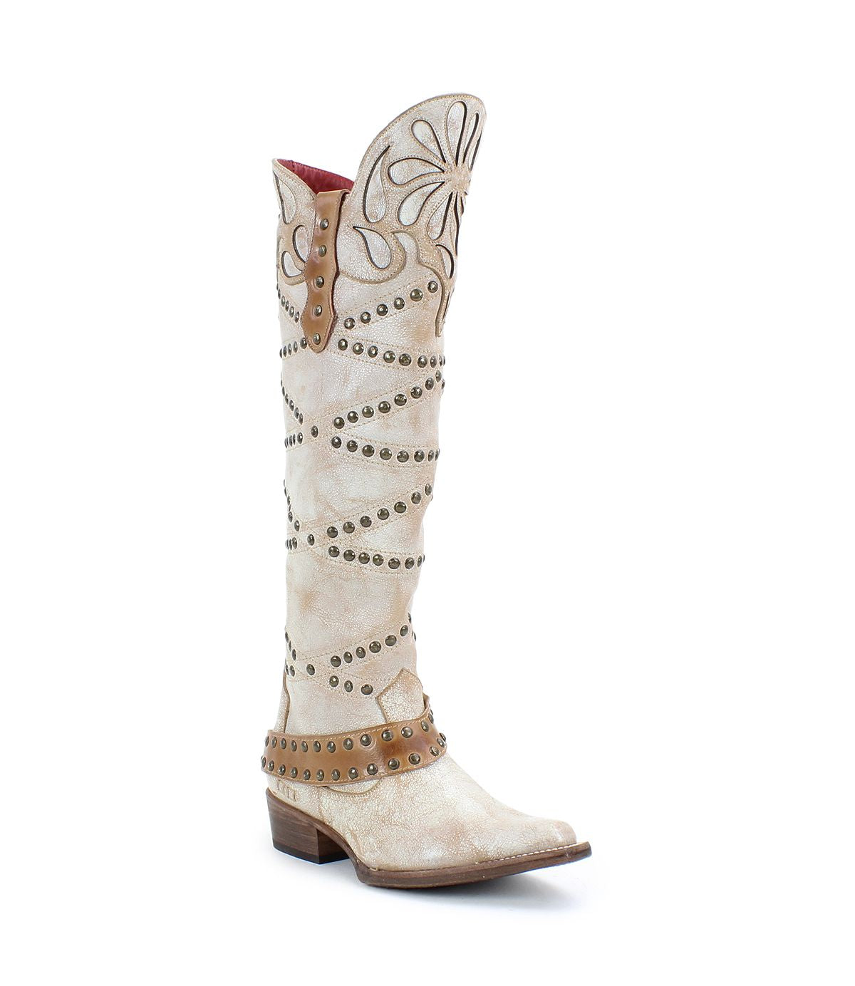 Betting by Bed|Stü: Tall white handcrafted leather boots featuring decorative stitching, floral inlays, and metal studs; designed with studded harness details and brown accents on the shaft, heel, and instep strap; completed with a low wooden heel.