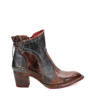 Introducing the Bed|Stü Bia: a single handcrafted ankle boot in brown and black premium vegetable-tanned leather, featuring a chunky heel, visible stitching, red sole, and decorative back lacing.