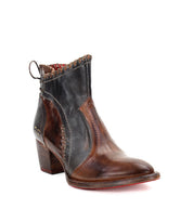 Introducing the Bia by Bed|Stü: a handcrafted brown and black ankle boot made from vegetable-tanned leather, featuring a medium block heel, decorative stitching, fabric inner lining, and a pull loop at the back—photographed against a white background.