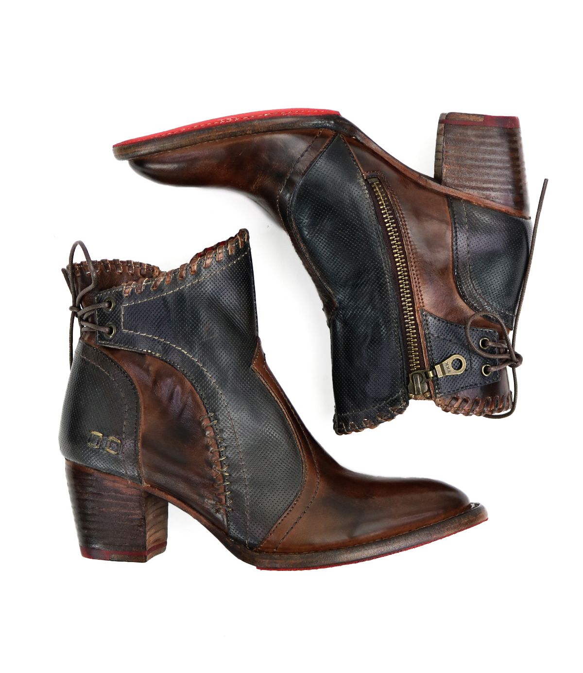 The Bia ankle boots by Bed|Stü feature handcrafted brown and black leather with side zippers, red soles, block heels, and decorative stitching, showcased against a white background.