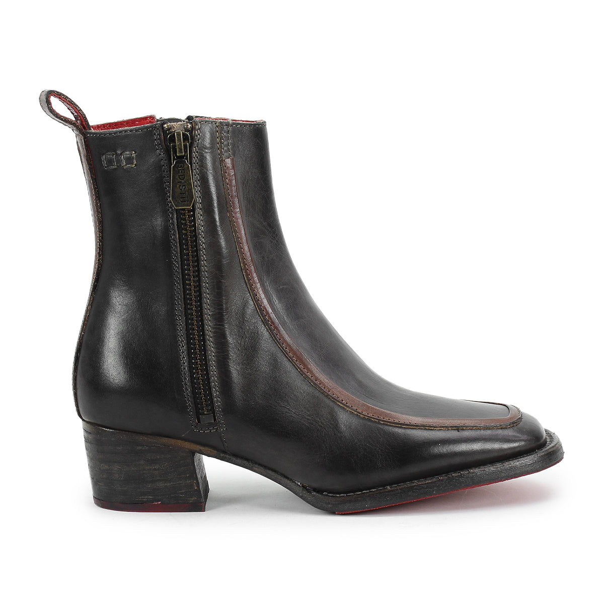 The Bitsy ankle boot by Bed|Stü features black leather, a square toe, side zipper, low stacked heel, and red interior lining, displayed in a side profile against a white background.