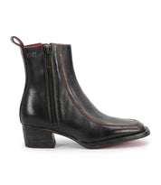 The Bitsy ankle boot by Bed|Stü features black leather, a square toe, side zipper, low stacked heel, and red interior lining, displayed in a side profile against a white background.