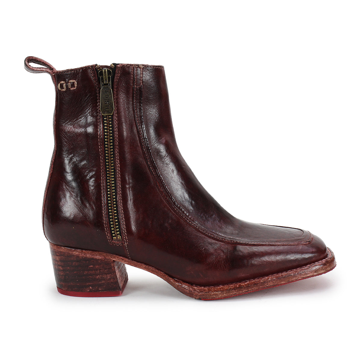 The Bed|Stü Bitsy is a single dark brown leather ankle boot featuring a side zipper, stacked heel, and pull tab at the back, photographed on a white background.