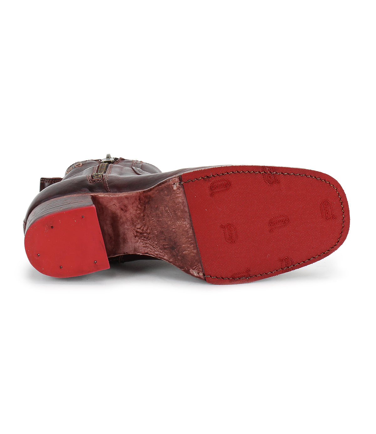 The Bed|Stü Bitsy boot is shown sole up, highlighting its red textured rubber sole with visible tread patterns, stitched edges, and a sturdy stacked heel.