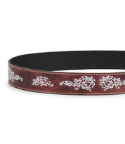The Blaze JB by Bed|Stü is a brown full-grain leather belt featuring intricate white stitched patterns and prominent white stitching along the edges, finished with an antique-style buckle and showcased against a plain white background.