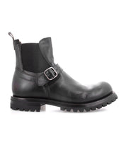 The Boast ankle boot by Bed|Stü is crafted from black full-grain leather and features a side buckle, an elastic panel, a pull tab, and a thick treaded sole. It is shown in profile view against a white background.