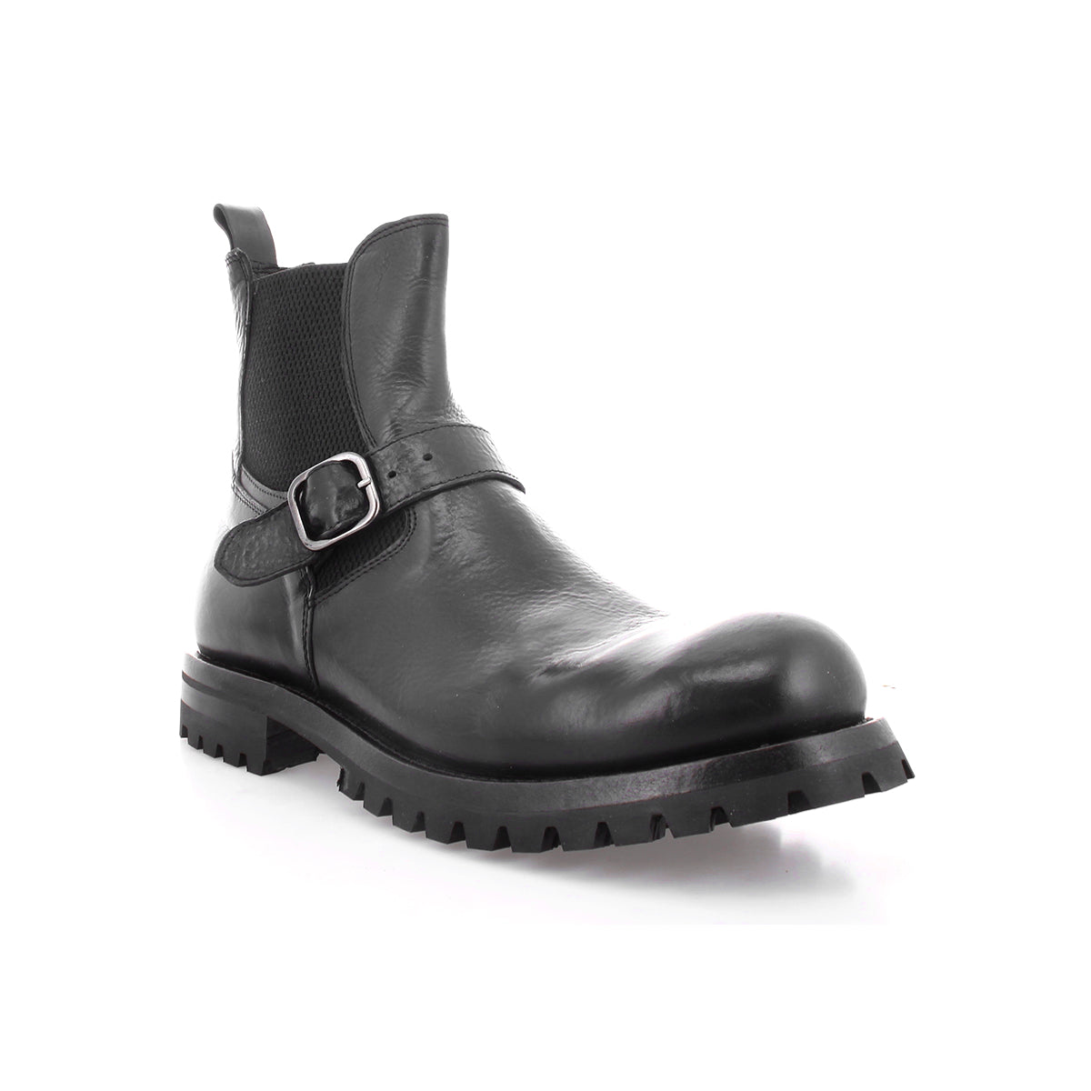 Boast by Bed|Stü is a black leather ankle boot crafted from full-grain leather, featuring a side buckle, elastic panel, pull tab, and thick rubber lug sole—shown on a white background. This classic men's Chelsea boot combines the enduring quality of Italian leather boots with modern details for everyday wear.