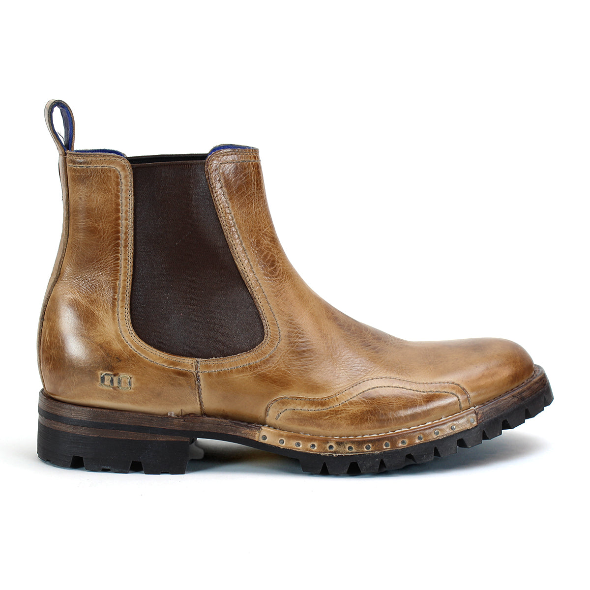 Introducing the Brady Trek by Bed|Stü—a timeless Chelsea boot crafted in tan leather, featuring a dark elastic side panel, convenient back pull tab, decorative stitching, and a textured treaded outsole for enhanced grip. Shown here in side profile view, it's the perfect versatile boot for any occasion.