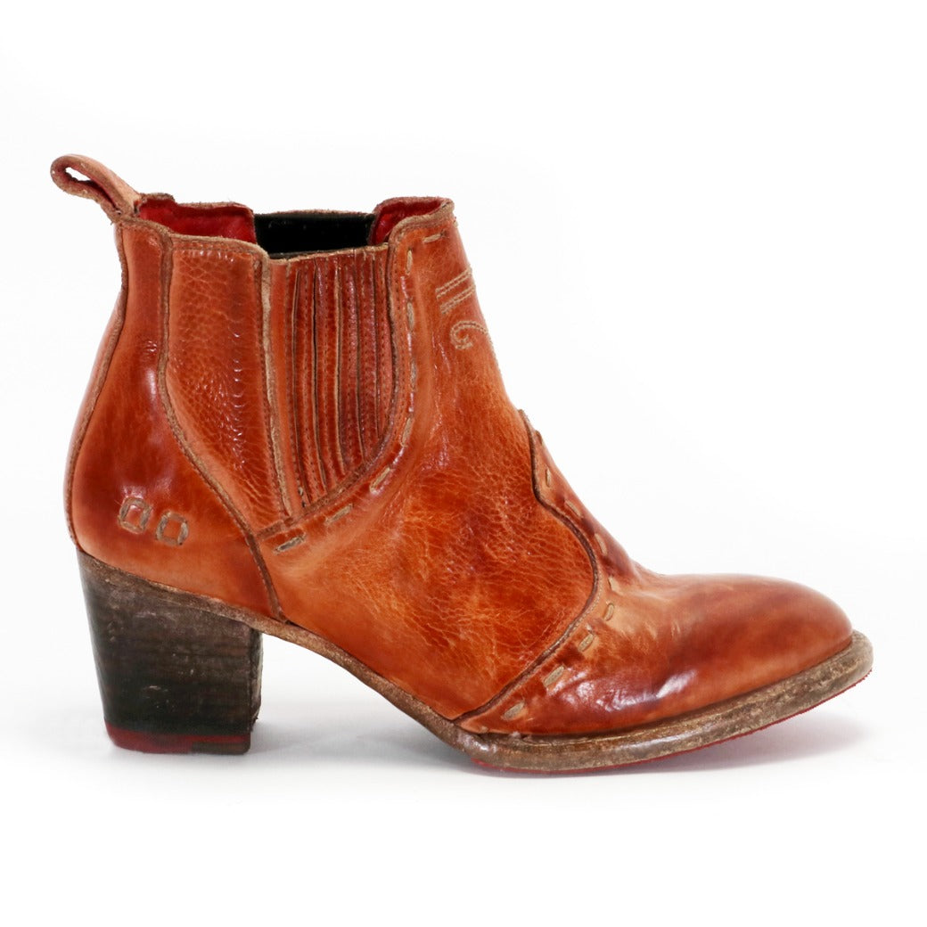 The Bed|Stü Brie II is a brown leather ankle boot featuring a stacked heel, elastic side panels, visible stitching, and a cushioned insole for all-day comfort, shown against a white background.