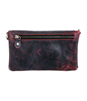 The Cadence by Bed|Stü is a rectangular black leather pouch featuring bold red accents, a visible top zipper, and a small leather pull tab on the left side. Expertly crafted from premium vegetable-tanned leather for lasting durability, this sleek accessory seamlessly transitions into a stylish crossbody clutch for versatile everyday use.