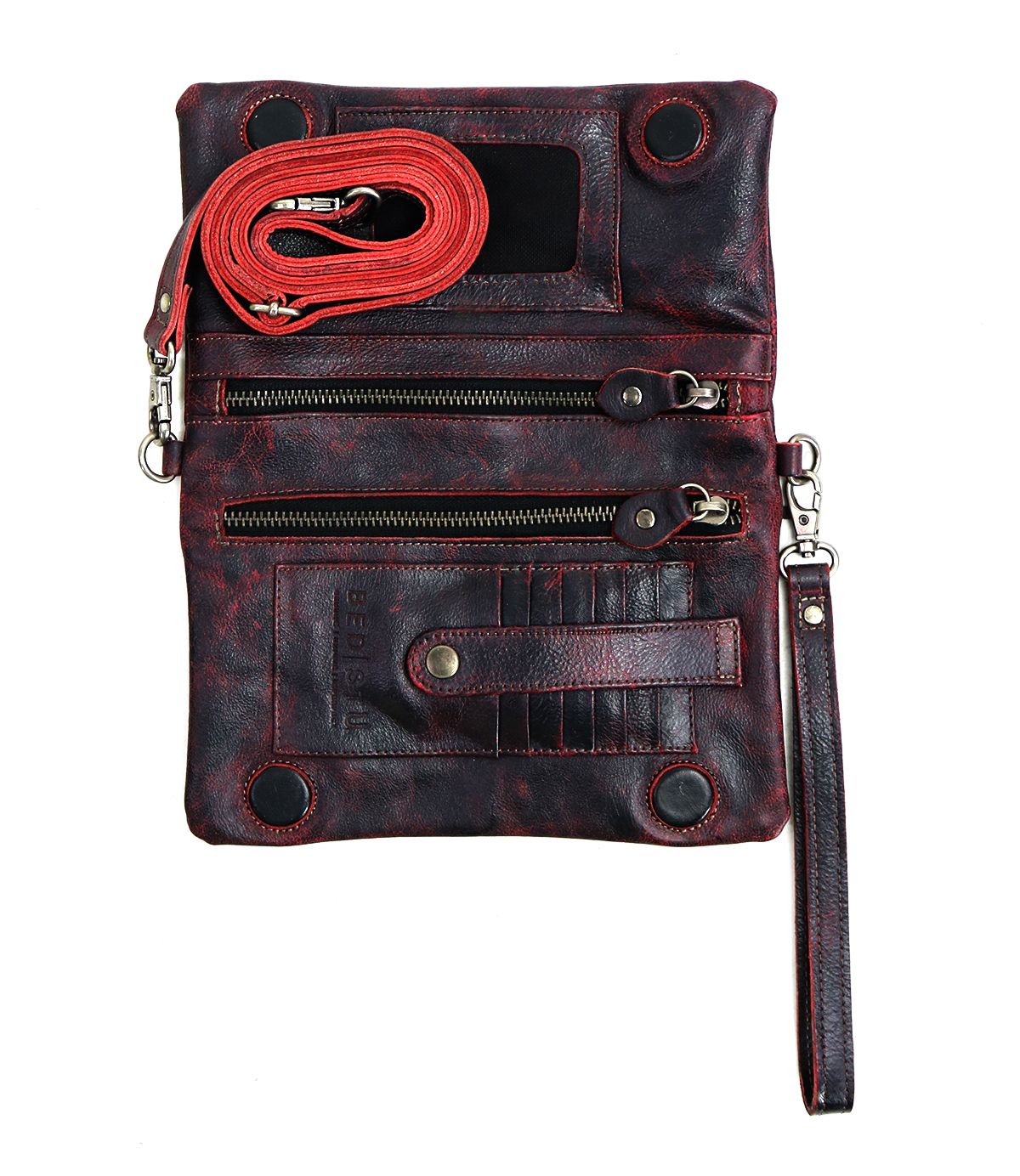 The Cadence by Bed|Stü is a black and red crossbody clutch made from vegetable-tanned leather, featuring three zippered pockets, card slots, a detachable wrist strap, and a coiled red shoulder strap in its versatile 3-in-1 wallet design.