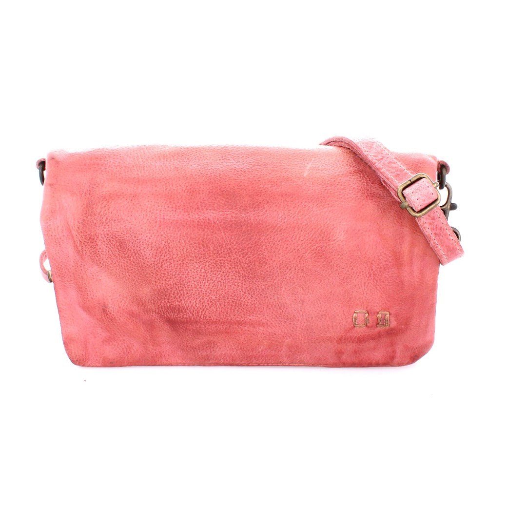 The Cadence by Bed|Stü is a pink leather crossbody clutch featuring a flap closure, adjustable strap, and a small metallic logo on the lower right corner, crafted from premium vegetable-tanned leather.