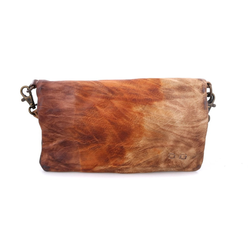 The Bed|Stü Cadence is a rectangular brown vegetable-tanned leather clutch featuring a marbled texture and two small metallic rings at either end for attaching a strap—perfect for carrying as a crossbody, clutch, or transforming into a versatile 3-in-1 leather wallet.