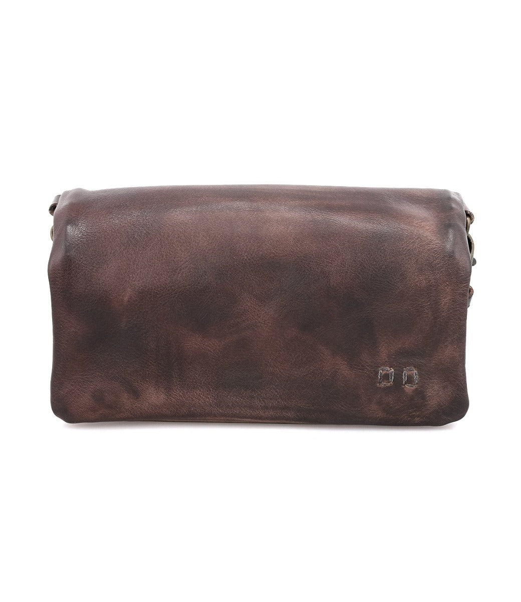 The Cadence pouch by Bed|Stü is a rectangular brown accessory, crafted from vegetable-tanned leather featuring a smooth, slightly worn finish and accented with two small metal rivets on the lower right corner, displayed against a white background.