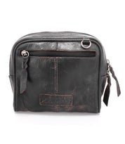 Introducing Capture by Bed|Stü: a compact, black leather crossbody bag featuring a front zipper pocket, distinctive brown stitching, and dual zipper pulls. Set against a white background, this stylish handbag perfectly combines timeless design with everyday functionality.