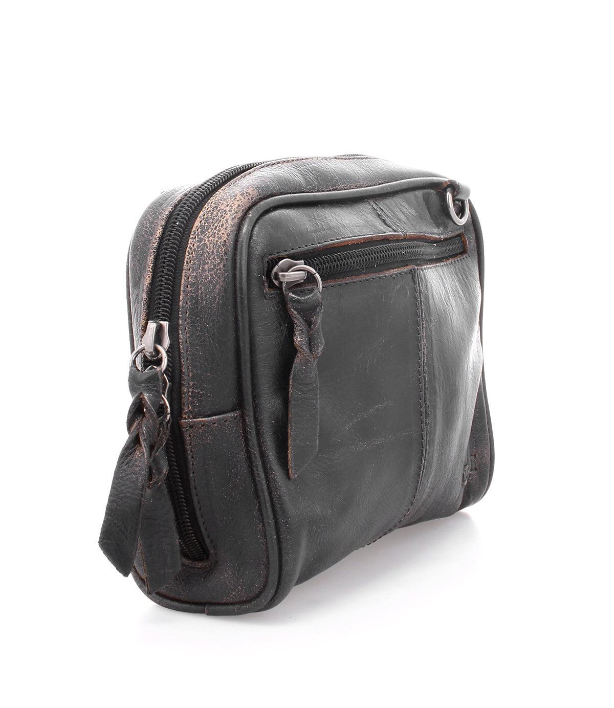 The Bed|Stü Capture, a small black leather crossbody bag with a front zipper pocket and visible scuff marks, is photographed on a white background—this compact handbag exudes both character and timeless style.