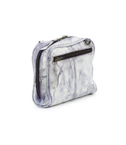 The Bed|Stü Capture is a small, rectangular, light gray leather crossbody bag featuring a front zipper pocket and visible stitching. This compact handbag is displayed against a white background.