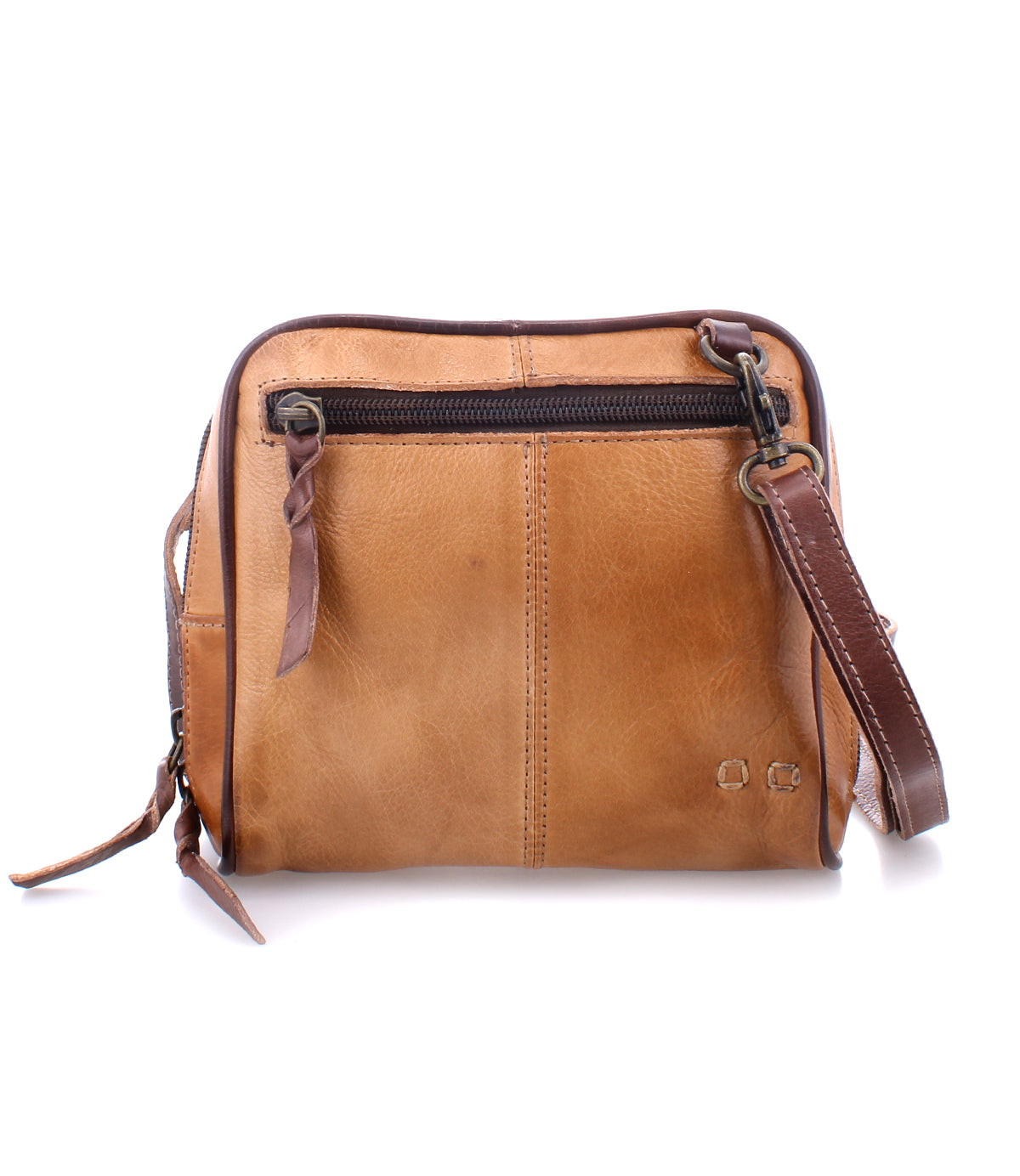 The Bed|Stü Capture is a brown leather crossbody bag featuring a front zipper pocket, detachable strap, and visible stitching, shown here as a compact handbag against a white background.