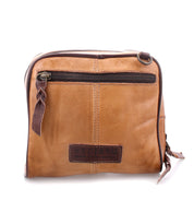 Discover the Capture by Bed|Stü—a small tan leather crossbody bag featuring a front zipper pocket, rich dark brown leather accents, and the signature "Bed|Stü" label on the front. Expertly handcrafted, this purse blends timeless style with practical functionality, making it the ideal compact handbag for carrying your essentials every day.