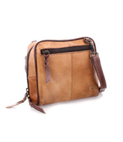 Introducing Capture by Bed|Stü: This light brown handcrafted purse, made from premium leather, features a dark brown zipper pocket on the front and an adjustable shoulder strap for easy style and everyday convenience.