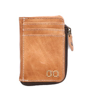 The Bed|Stü Carrie is a light brown compact leather wallet featuring front stitching, multiple card slots, a metal zipper along one edge for a convenient zip compartment, and two small metallic squares in the bottom right corner.