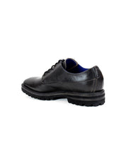 A single Bed|Stü Carter black leather lace-up oxford dress shoe with a rugged outsole, shown from the back against a white background.