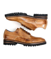 Two Carter brown leather oxford dress shoes by Bed|Stü, featuring black rubber soles and Goodyear welt construction, are positioned horizontally, one above the other, against a white background.