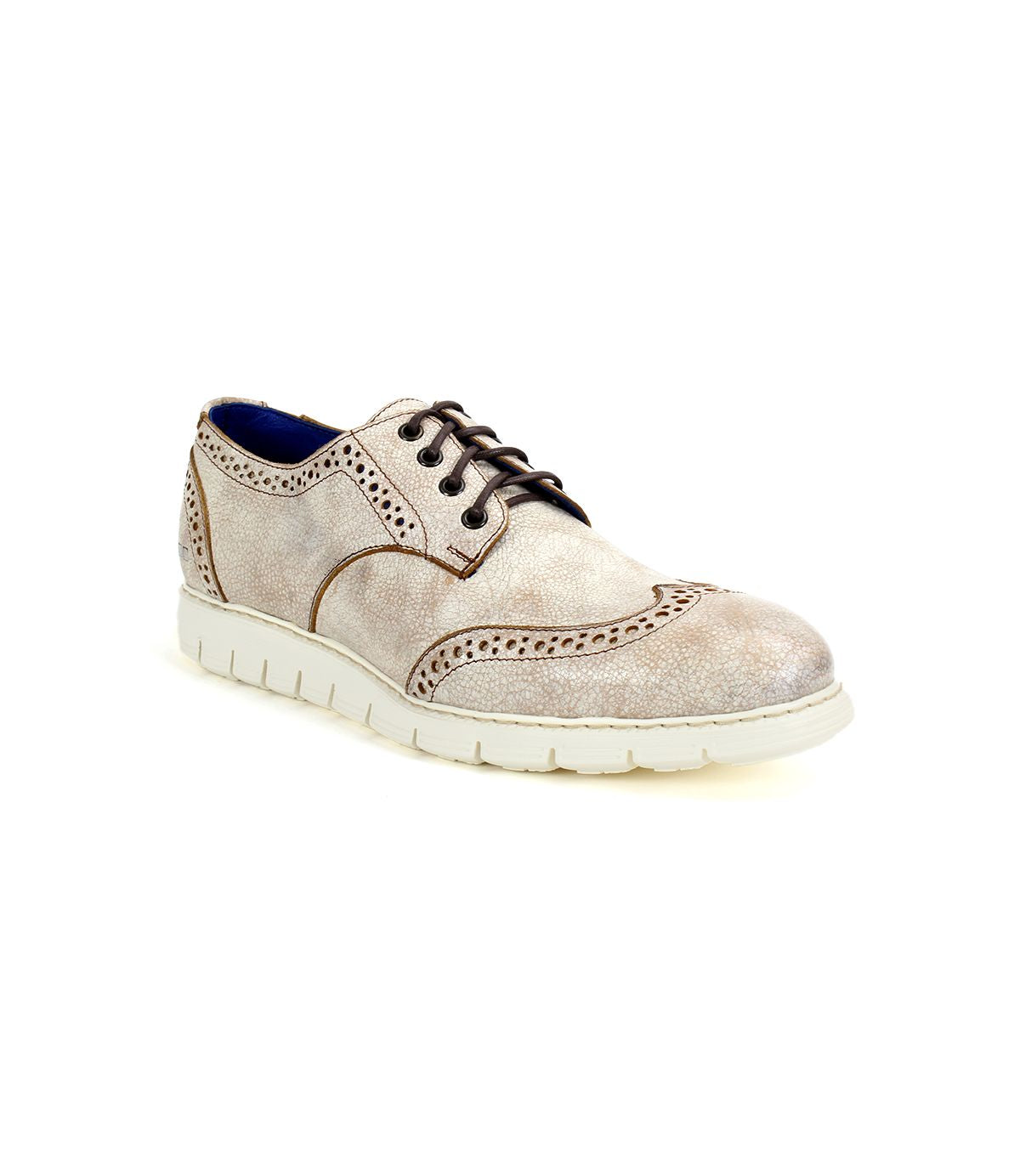 The Bed|Stü Cayuga II is a light beige leather derby shoe with classic brogue detailing and decorative perforations, accented by dark laces and set atop a white rubber sole, shown against a plain white background.