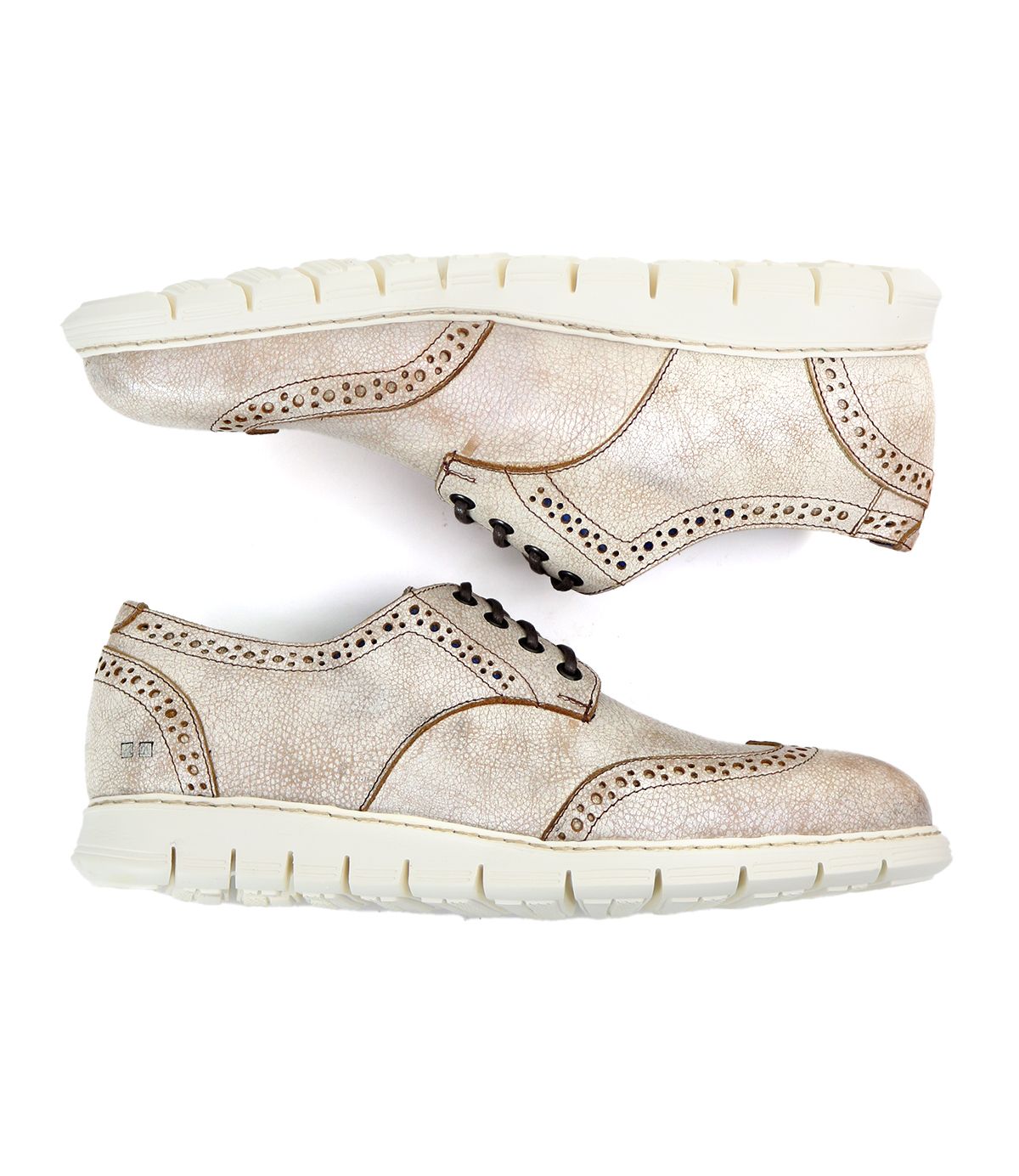 A pair of Bed|Stü Cayuga II beige wingtip shoes with brogue detailing, black laces, and thick white rubber soles, displayed side by side on a white background.