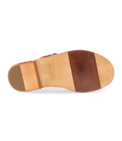 The underside of the Bed|Stü Charka features tan vegetable vacchetta leather, a stacked brown heel, and a logo stamped in the arch area.