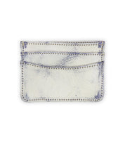 The Chuck by Bed|Stü is a white slim wallet with two slots and visible stitching along the edges. This compact card wallet showcases some worn and distressed areas, making it a practical choice for everyday carry.