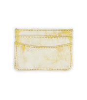 The Chuck by Bed|Stü is a small, rectangular card wallet crafted from textured material in a yellowish-white hue, featuring visible stitching. Shown against a plain white background, it's the perfect compact accessory for everyday carry.