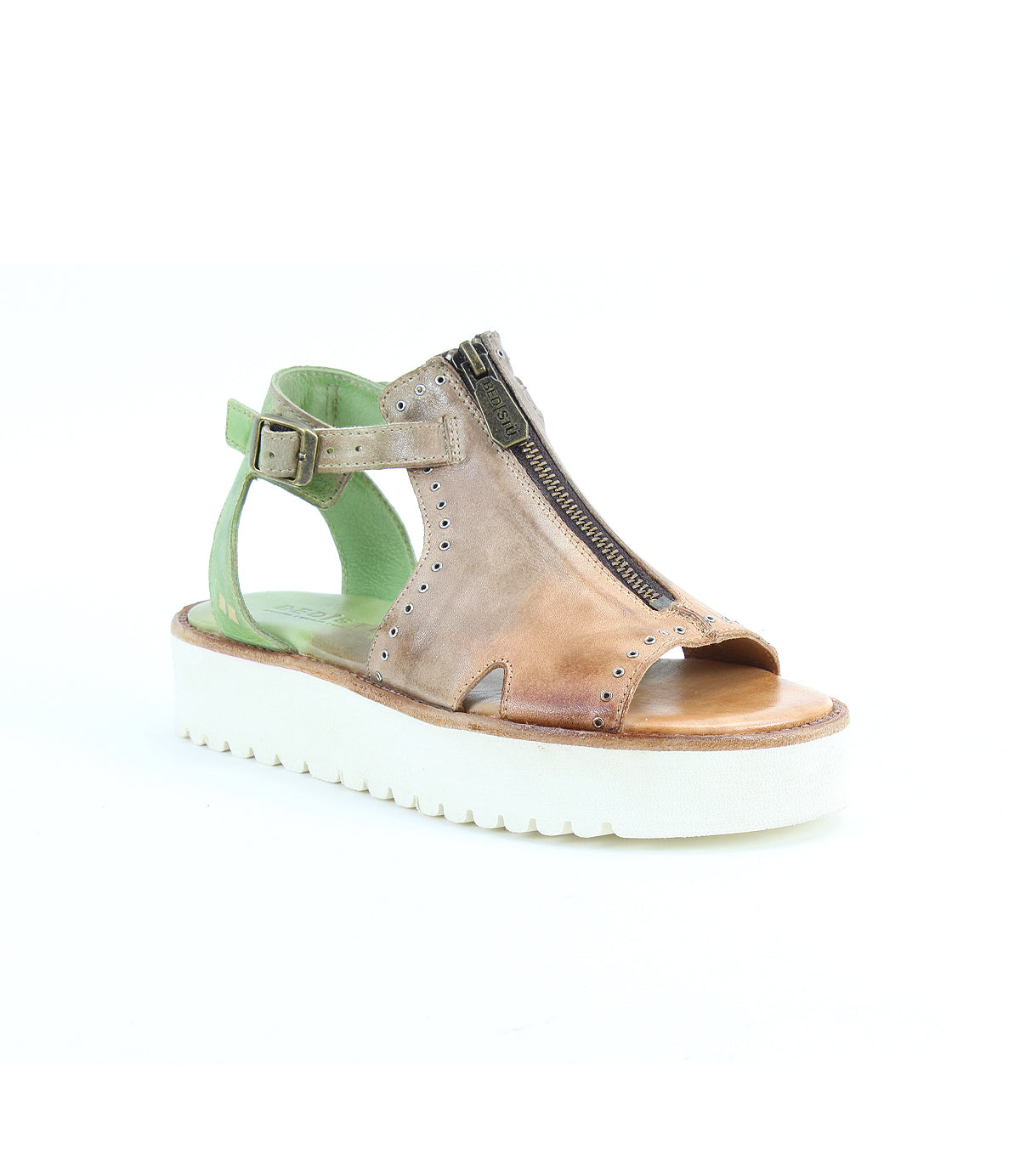 The Clancy by Bed|Stü is a tan leather sandal featuring stylish side cutouts, a front zipper, open toe, ankle strap with buckle, and a contrasting white platform sole. Designed with a cushioned insole for added comfort, this sandal is perfect for those seeking fashionable platform shoes. Displayed against a white background.
