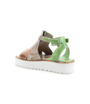 The Bed|Stü Clancy sandal, featuring a brown and green cutout leather design, an open heel, cushioned insole, white platform sole, and an ankle strap, is displayed on a white background.