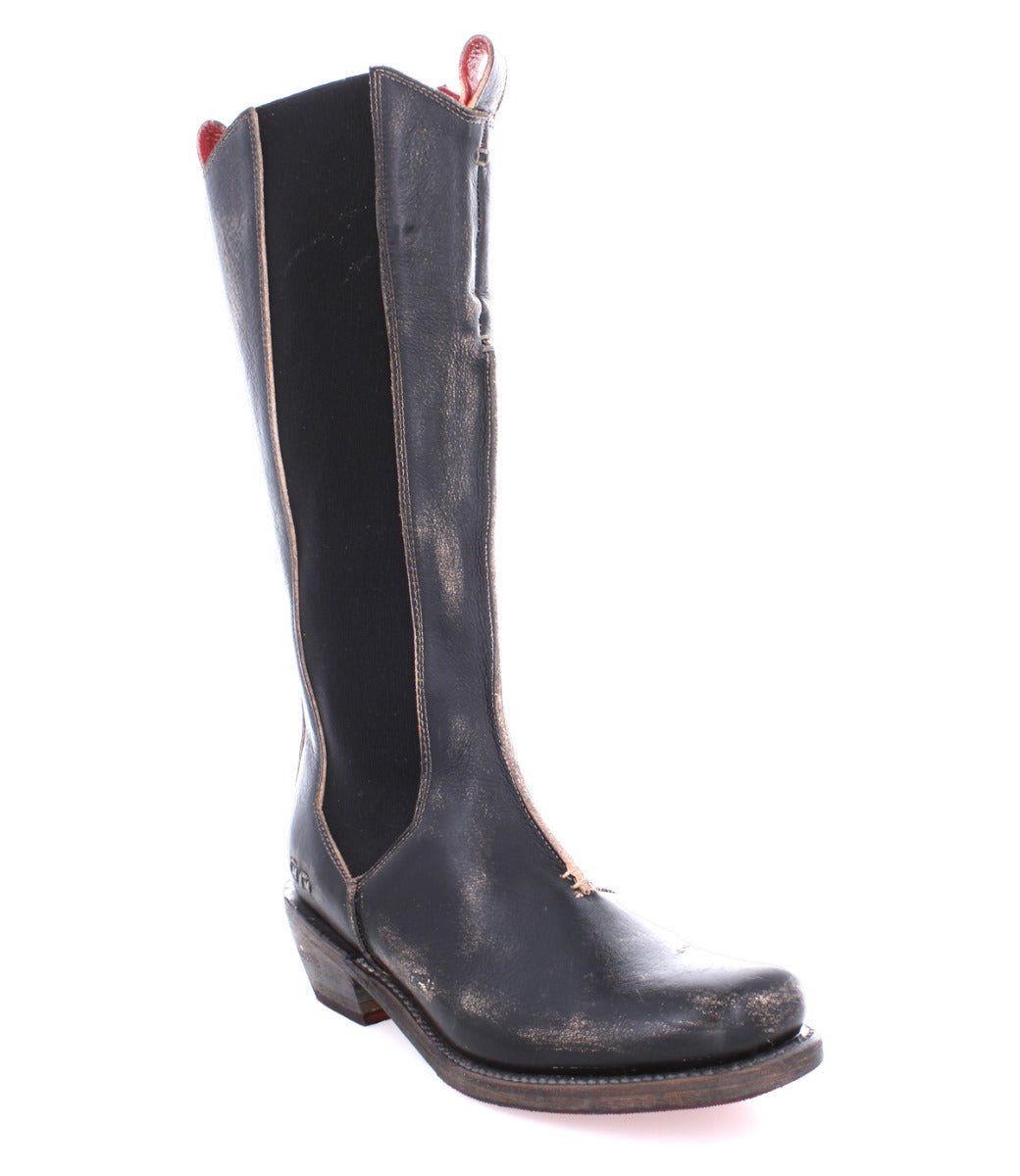 A single Clarisse boot by Bed|Stü is displayed against a white background. This tall, black leather western boot with brown trim and a low heel features classic mid-calf styling and distinctive western heel detailing, giving it an authentic touch and a slightly worn appearance.