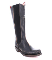 A single Clarisse boot by Bed|Stü is displayed against a white background. This tall, black leather western boot with brown trim and a low heel features classic mid-calf styling and distinctive western heel detailing, giving it an authentic touch and a slightly worn appearance.