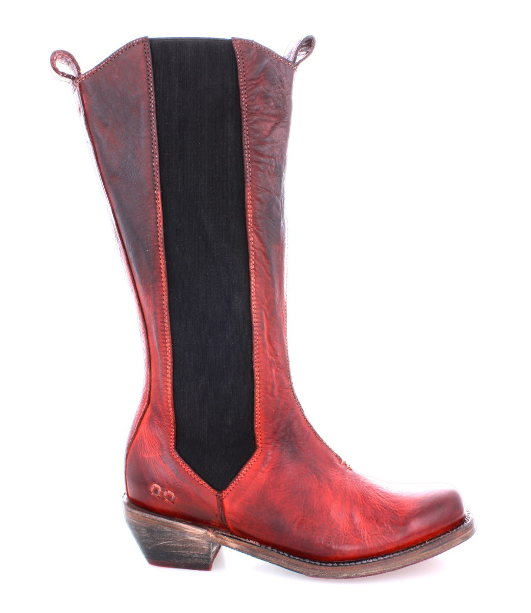 The Bed|Stü Clarisse is shown in profile on a white background—a single red and black leather cowboy boot featuring a pointed toe, mid-calf tall shaft, pull tabs, and a low angled western heel.