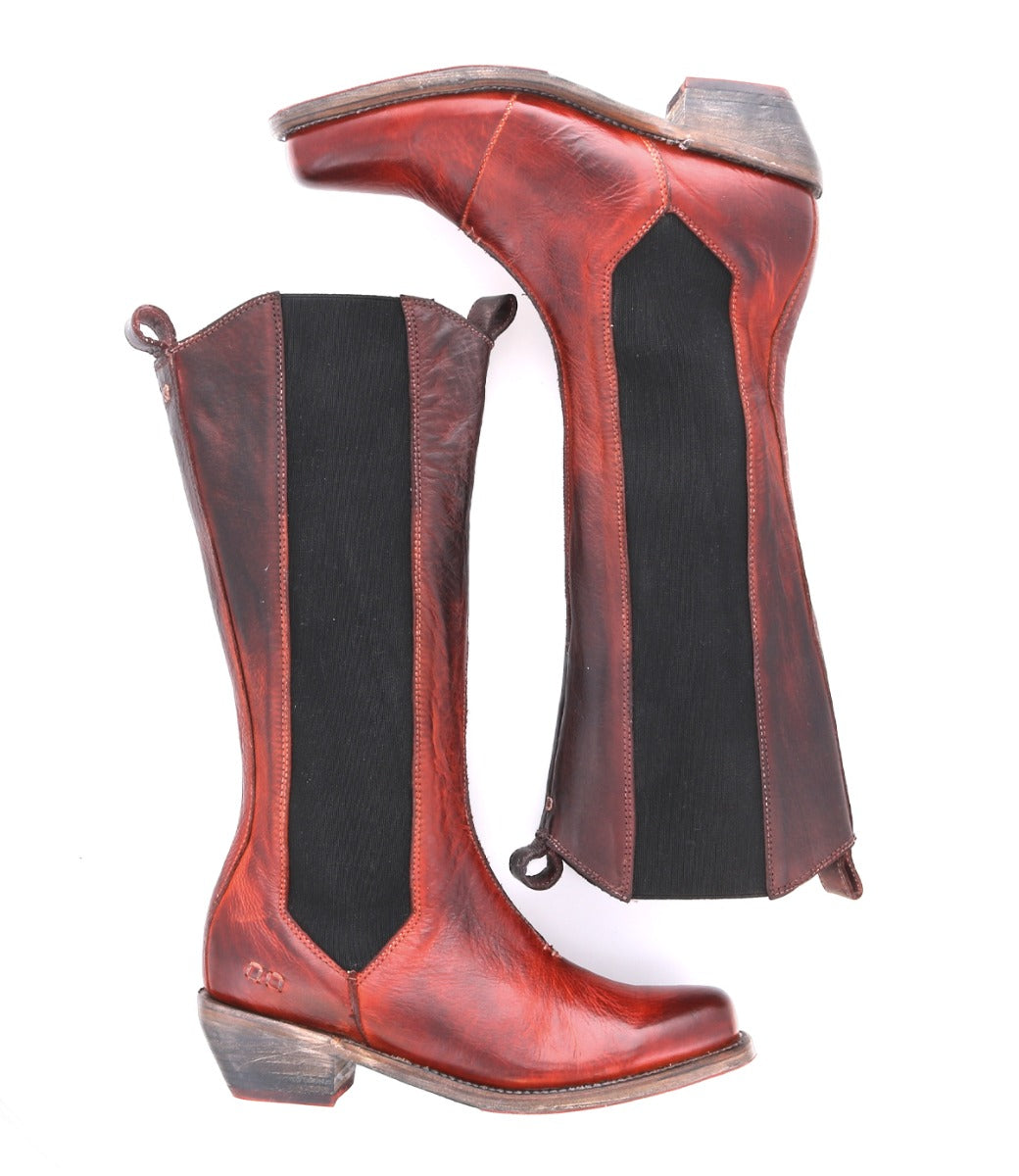A pair of Bed|Stü Clarisse mid-calf tall boots in red-brown leather, featuring black elastic side panels, pull tabs, and a low western heel, displayed from the side and bottom views against a white background.
