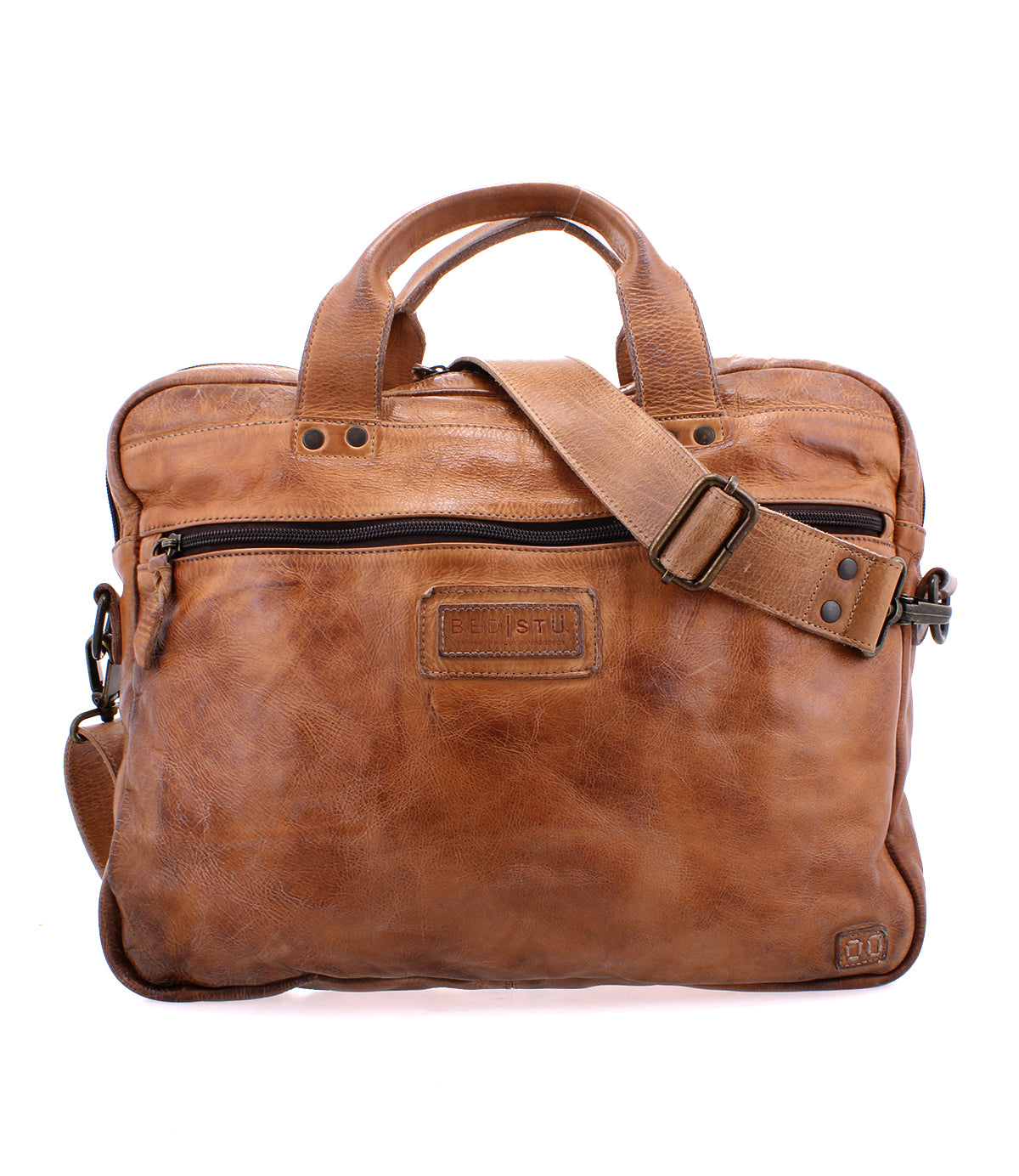 Introducing the Bed|Stü Conclusion: a brown leather messenger bag featuring two short handles, an adjustable shoulder strap, visible front stitching, and a convenient front zipper pocket. Crafted from premium vegetable-tanned leather, the Conclusion also offers a dedicated laptop section for enhanced convenience and organization.