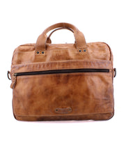 The Bed|Stü Conclusion is a brown vegetable-tanned leather briefcase with a top handle, front zipper pocket, and visible stitching. It features a dedicated laptop section and is displayed against a white background.