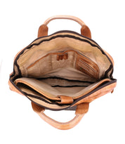The Bed|Stü Conclusion briefcase, crafted from tan vegetable-tanned leather, opens to reveal a beige fabric lining with multiple compartments, pen slots, a zippered pocket, a dedicated laptop section, and two top handles.