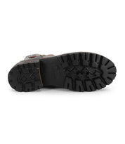 The image features the treaded sole of the Bed|Stü Daring boot, viewed from below, showcasing its textured black rubber outsole.