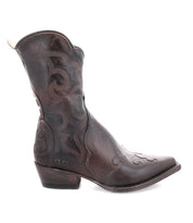 A single Deuce cowboy boot by Bed|Stü, crafted from dark brown vegetable-tanned leather with detailed stitching, a medium heel, and a pointed toe, is displayed in side profile against a white background.
