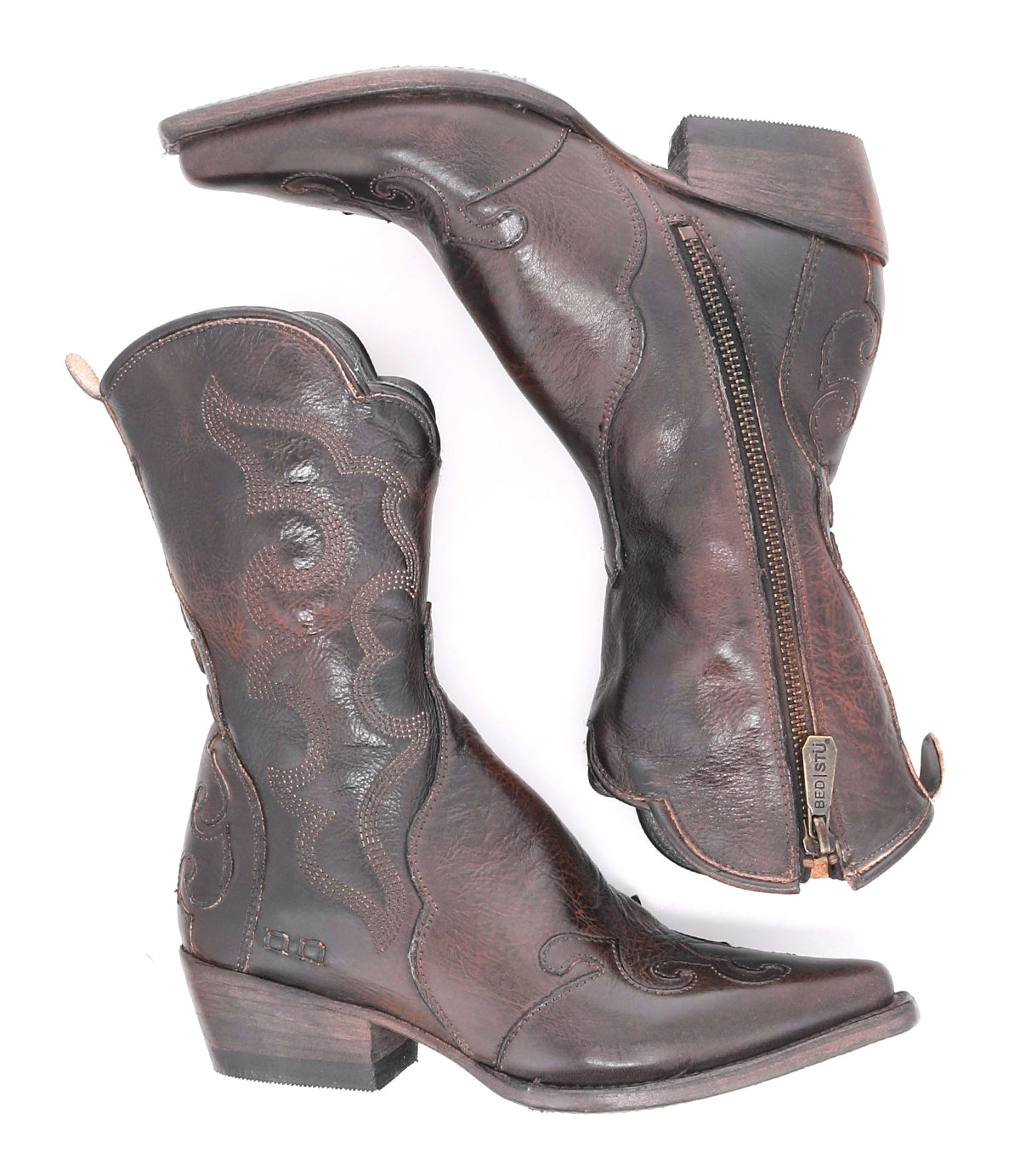 A pair of Deuce Western boots by Bed|Stü, crafted from vegetable-tanned dark brown leather with detailed stitching, low heels, pointed toes, and convenient side zippers, shown on a white background.