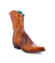 Bed|Stü Deuce boots in brown vegetable-tanned leather showcase detailed Western-inspired stitching, a pointed toe, and a short stacked heel; expertly crafted and photographed against a white background.
