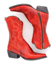 A pair of Bed|Stü Deuce boots in red vegetable-tanned leather, featuring detailed stitching, black heels, and side zippers, shown from the side and top views.