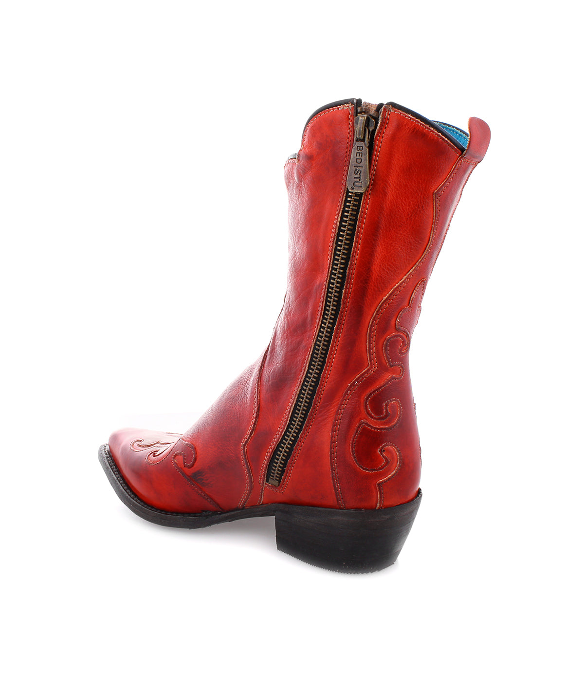 Bed|Stü Deuce—a red leather Western boot made from vegetable-tanned leather, showcases intricate stitching, a side zipper, a black sole, and is displayed with the heel facing forward against a white background.